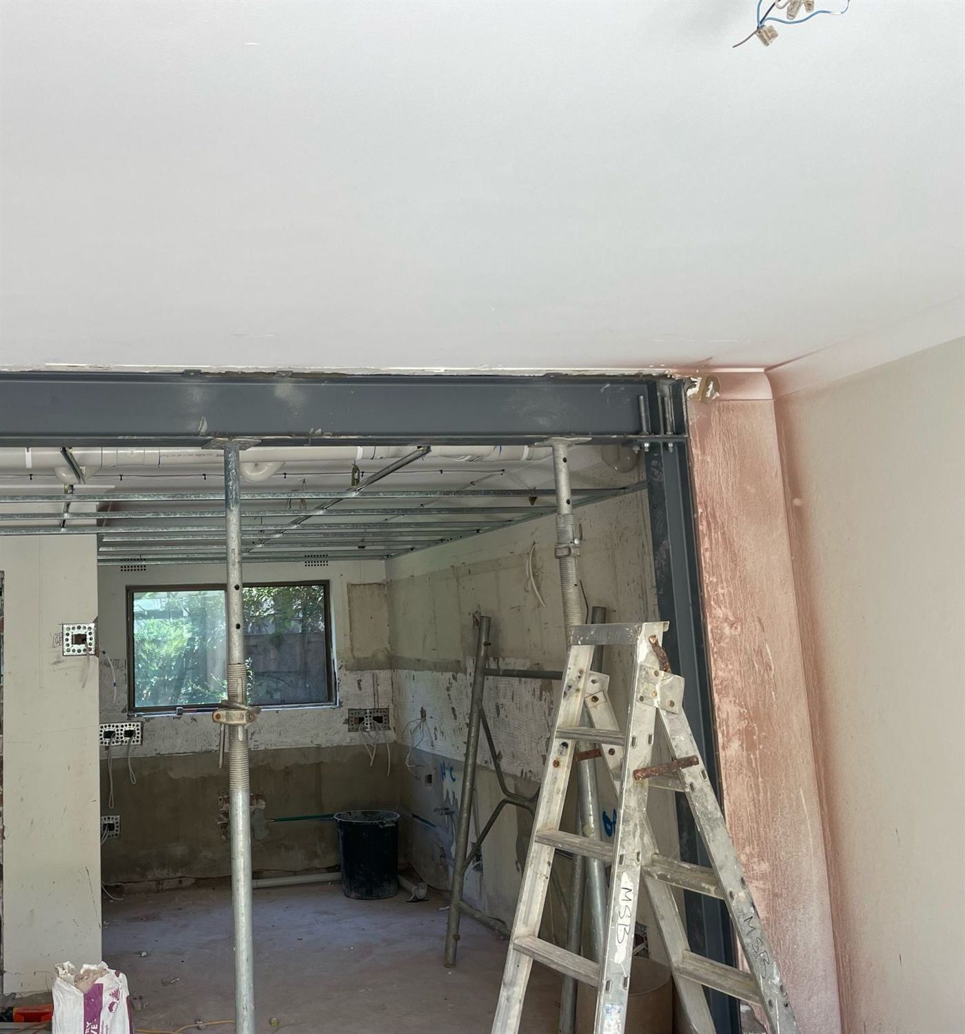 During construction — steel beam installed on temporary props